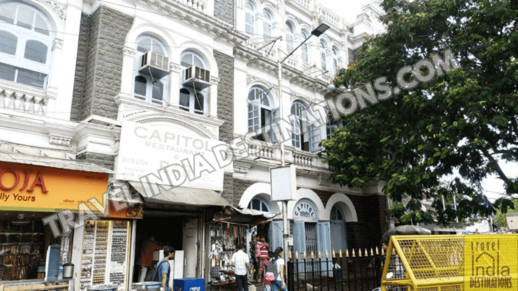 Exterior shot of Capitol Cinema in Mumbai with its white and grey renovated appearance.