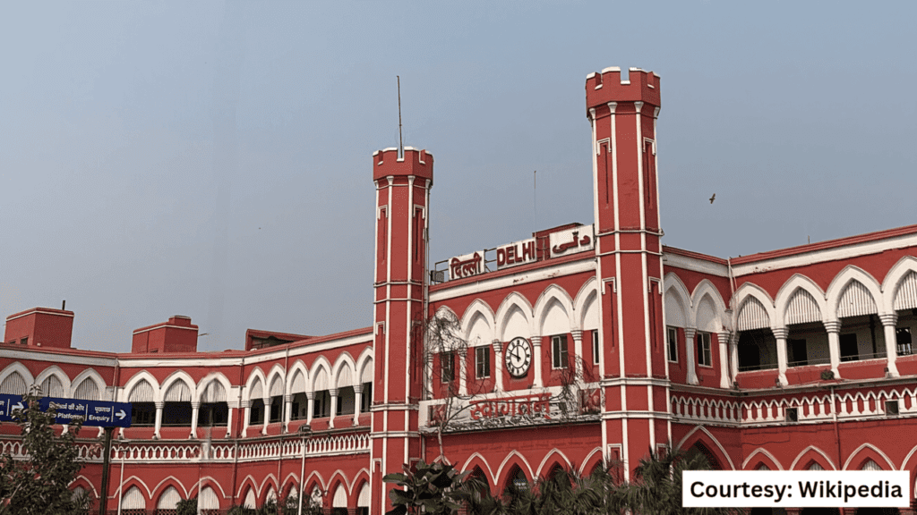 An exterior shot of Delhi Junction railway station, historic North Indian station opened in 1864, red stone building resembling Red Fort.