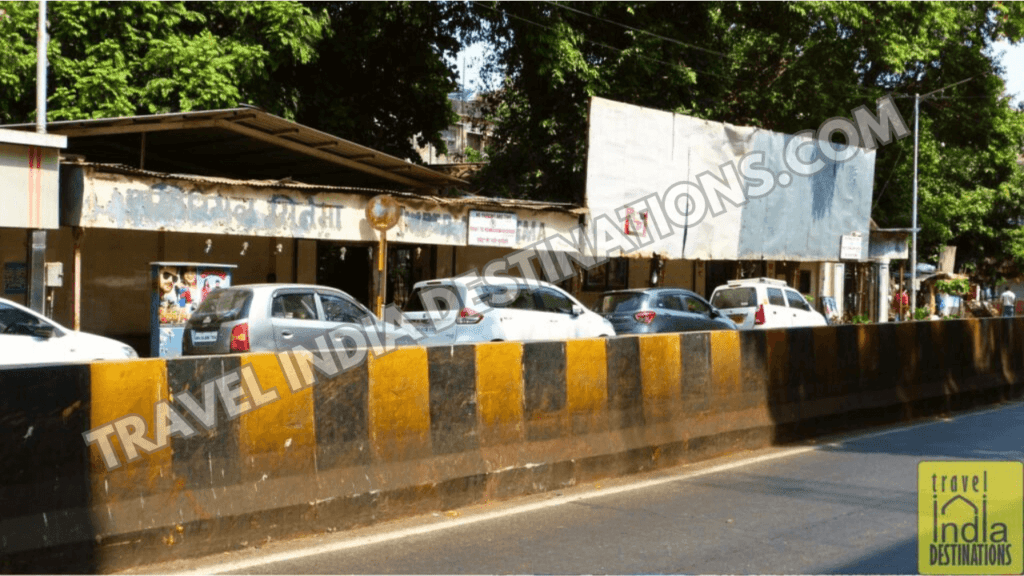 A picture of Imperial Cinema on Lamington Road in Mumbai with cars parked outside. 