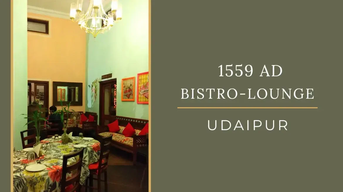 A picture of lounge area with colourful tableclothes and pillows and chandeliers at 1559 AD Udaipur.