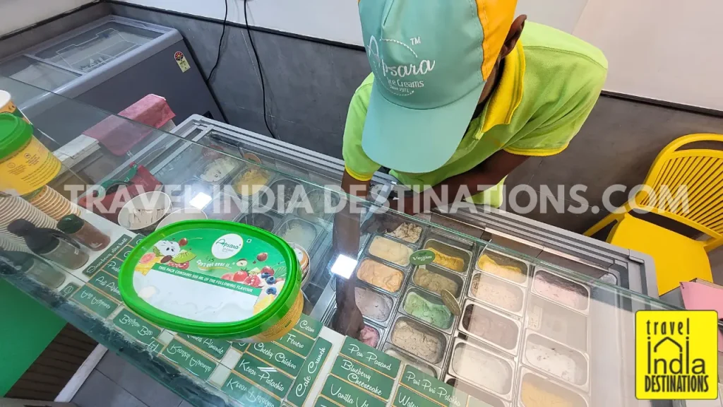 A shot of an employee scooping ice cream at Apsara Ice Cream Store in Vasai, one of the best ice cream brands offering fresh fruit ice creams in Mumbai.