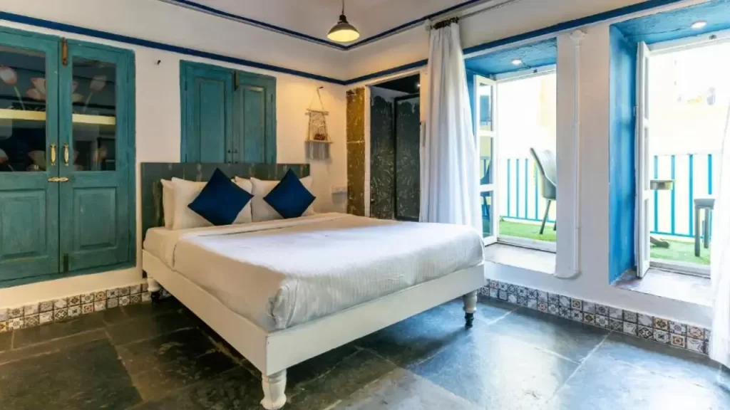 Cozy, pastel-toned bedroom at Barefoot Boutique Hotel Udaipur near the City Palace.