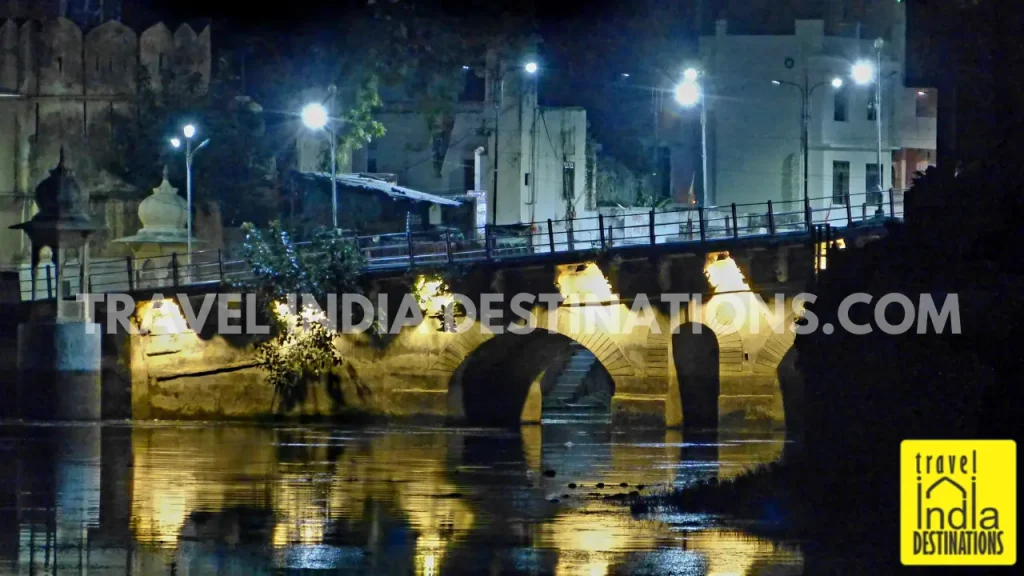 A shot of Chandpole Gate bridge from Tribute Restaurant in Udaipur with street lights on during evening hours.