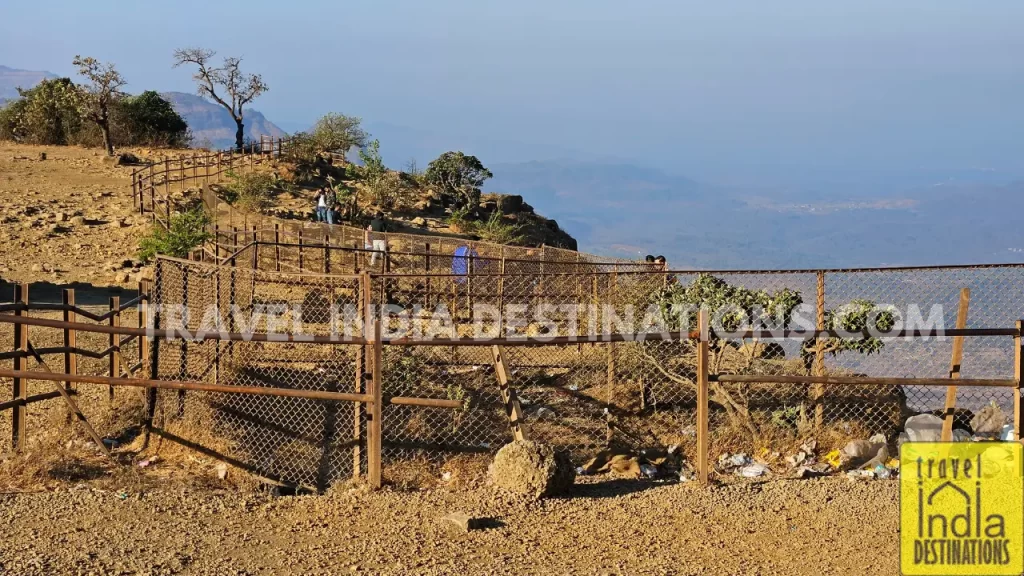 Couples at Tiger Point Lonavala beyond the barricades taking selfies and trash lying around