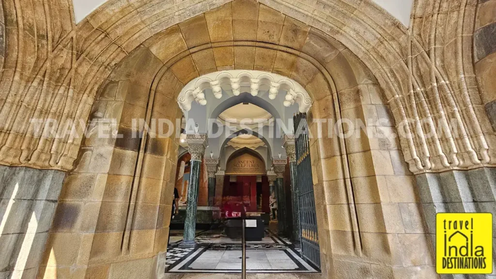 The main gate of Chhatrapati Shivaji Maharaj Vastu Sangrahalaya seen from the pavement, with its iconic pillars and security entrance.