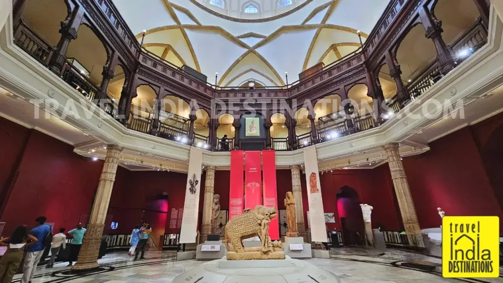 Wide-angle view of the Rotunda Gallery at CSMVS showing the central sculpture, wooden railings, arches, and the interior of the main dome.