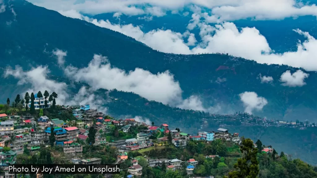 A scenic panoramic view of Darjeeling with clouds and hills, one of the best honeymoon destinations in India in April.