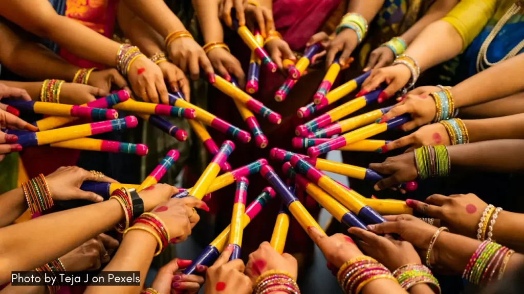 women enjoying a dandiya night with dandiya sticks