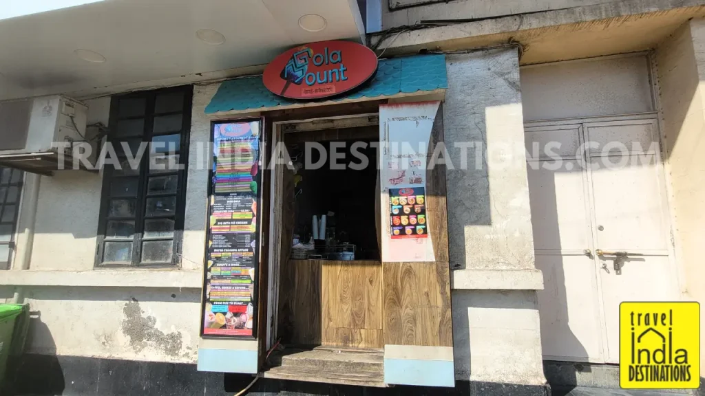 A shot of tiny stall of Gola Mount near Chowpatty selling a range of shaved iced with various syrup flavours.