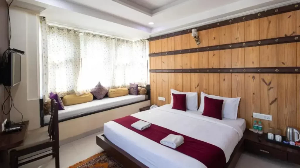 Lake-facing room with modern decor at Hide-In Udaipur, close to City Palace.