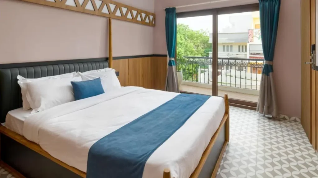 Interior shot of King Room with Balcony at Hotel Amaiti by StayXP, one of the best budget hotels near Pondicherry.