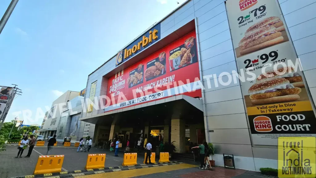 Exterior view of InOrbit Mall Malad with prominent Burger King & KFC hoardings and weekend crowd at the entrance