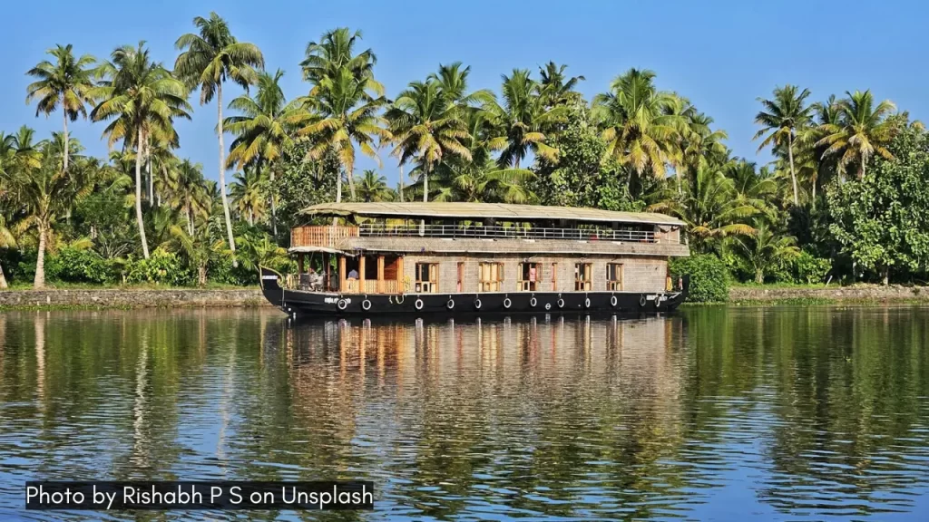An image of houseboat in the backwaters of Kumarakom in Kerala, one of the easy to reach honeymoon destinations in India.