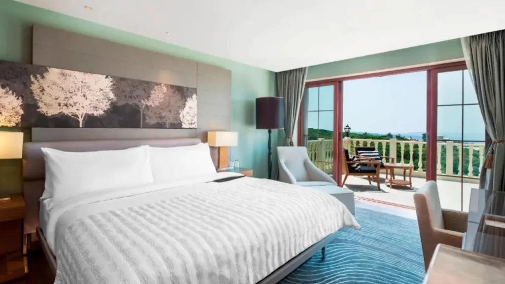 Pastel blue room with balcony and hill view at Le Méridien Mahabaleshwar