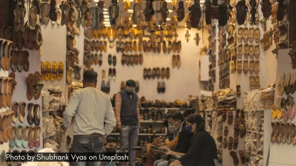 Customers buying mojris at a local leather footwear shop in Jaipur.