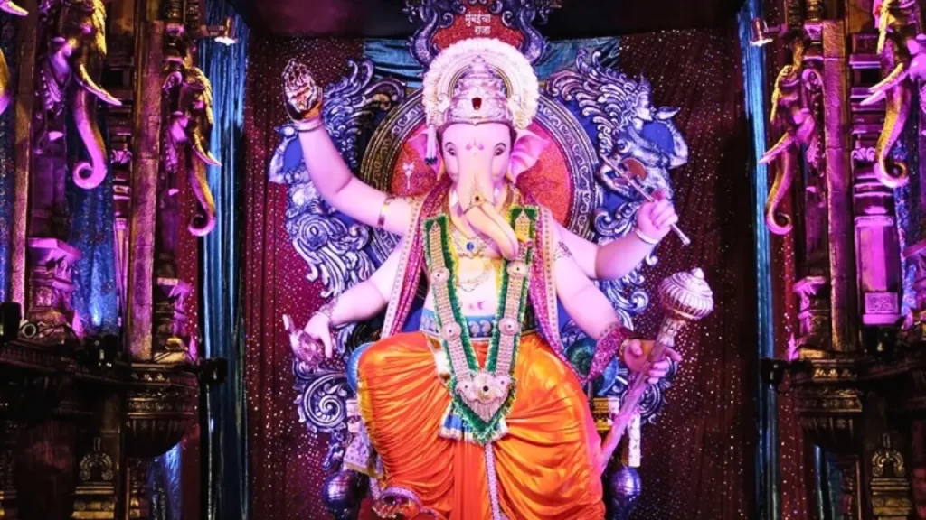 Elaborately decorated Ganesh idol at Ganesh Galli Pandal with a vibrant themed backdrop one of the oldest Ganpati pandals in Mumbai