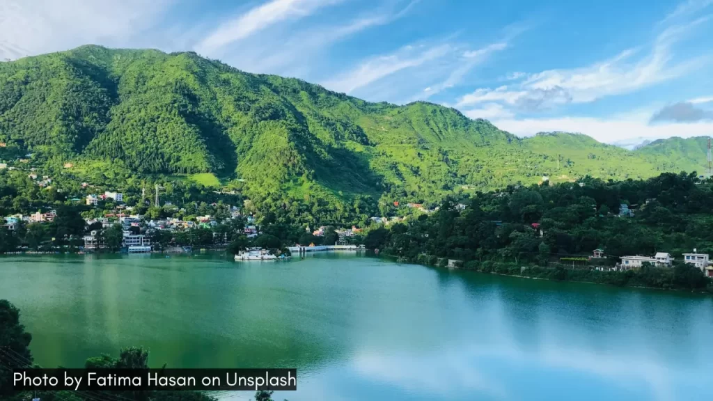 an overview of Bhimtal Lake in Uttarakhand with surrounding mountains