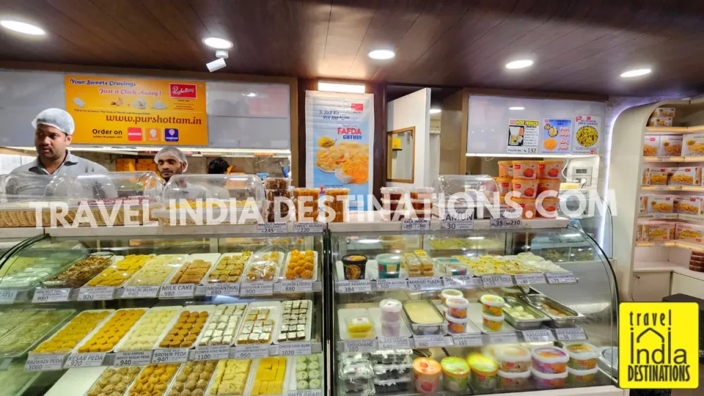 Interior of Purshottam Kandoi Haribhai Damodar Mithaiwala in Mumbai showing colorful mithai and Indian sweets on display, perfect for Diwali, weddings, and festive celebrations.