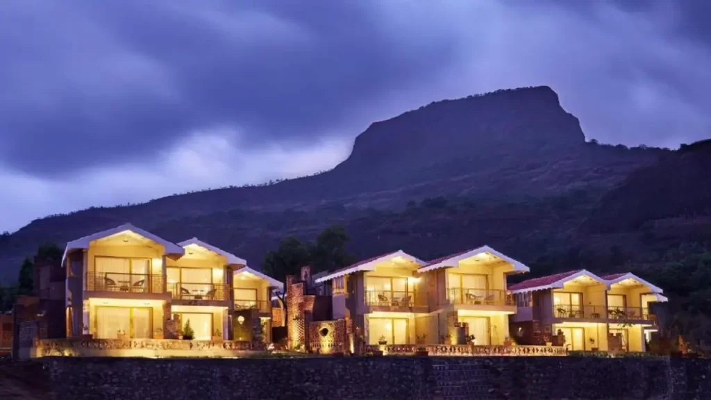 Saj By the Lake in evening light with Sindola Fort in the background is one of the best lake-side hotels near ghats in Maharashtra