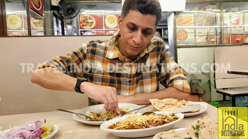 A person enjoying Salli Boti at the Queen Mary Restaurant in Mazgaon during the month of Ramadan.