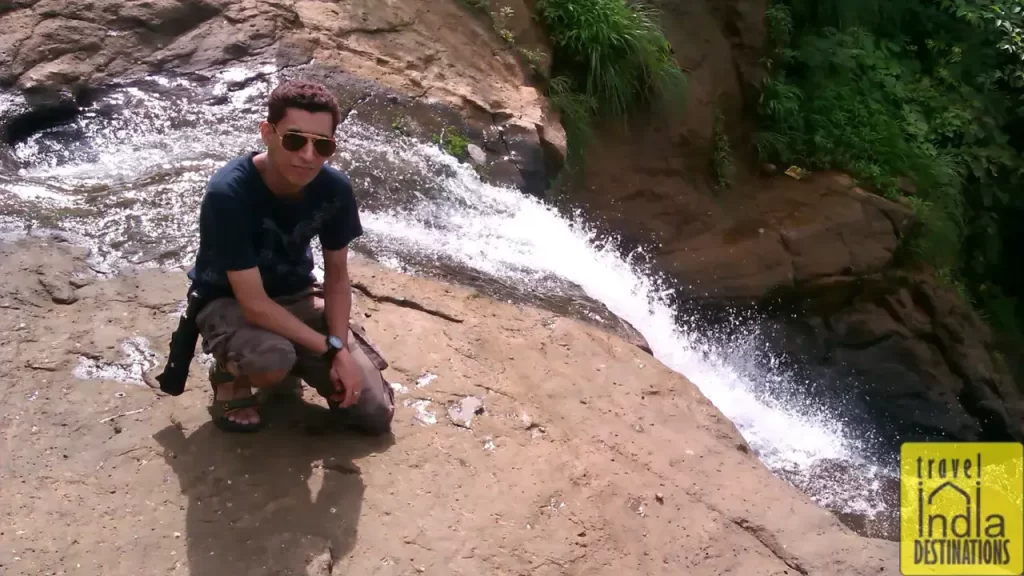 A person posing near a stream flowing near Bhushi Dam Lonavala.