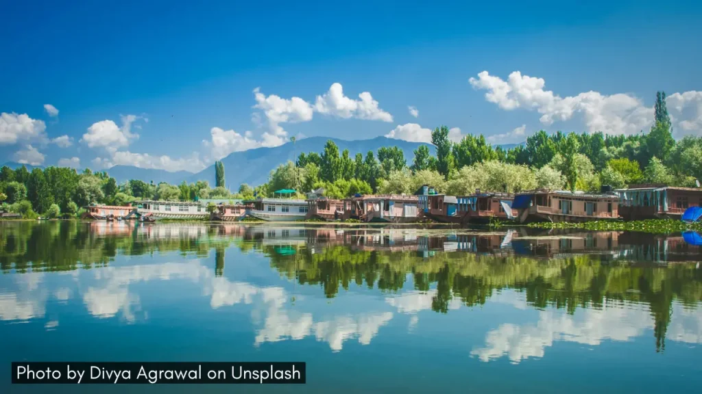 A picture of house boats reflected in the still waters of Dal Lake in Srinagar Jammu and Kashmir, one of the best minimoon destinations in India in March.