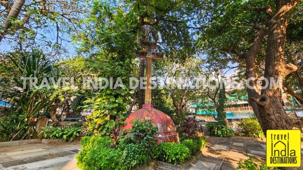 A cross located in the north-east corner of St Andrew's Church Bandra along with graves around it.