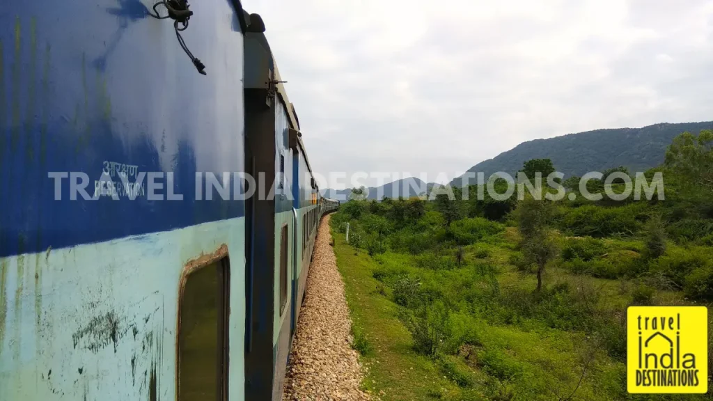 A shot of the Indian Railway train passing through the Aravalli Range reaching Udaipur.