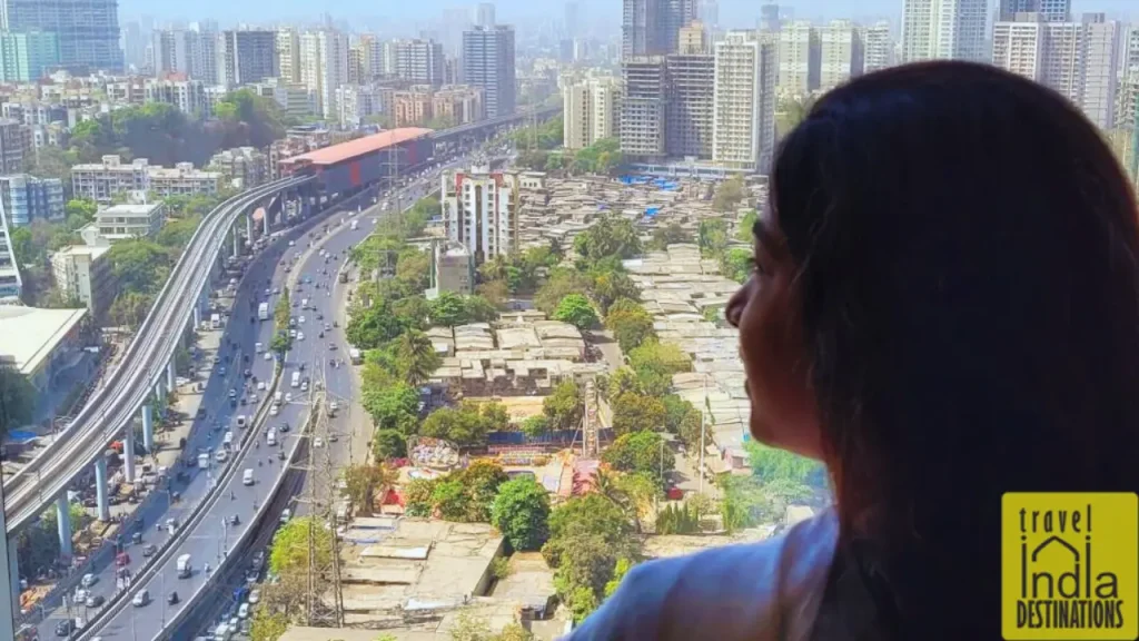 A woman enjoying the view of NH48 and Mumbai metro from Westin Mumbai Garden City, one of the top hotels in Mumbai.