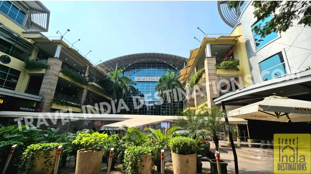 Front view of Viviana Mall Thane with lush greenery, palm trees, and a clean modern facade, one of the biggest malls in Thane