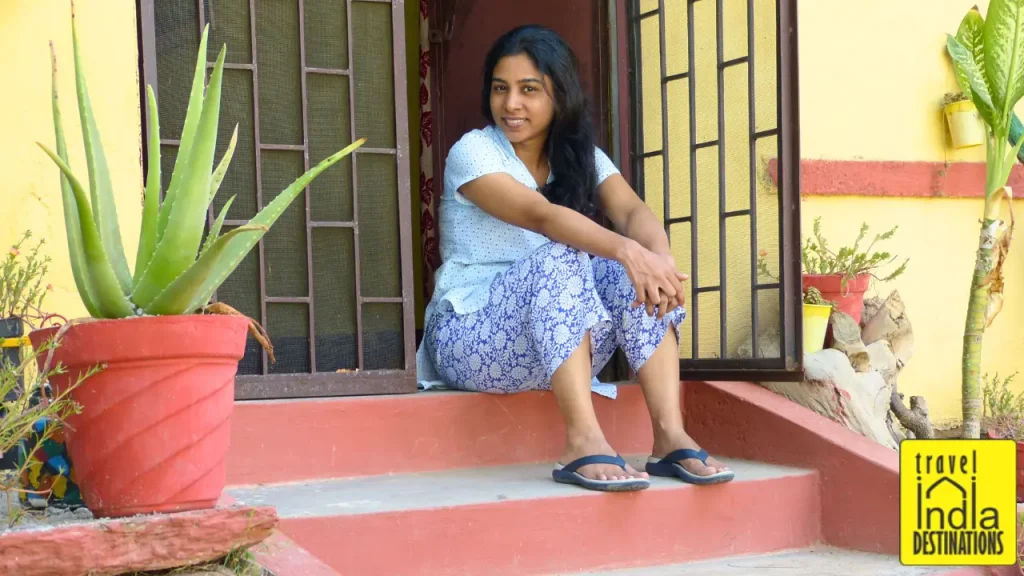 A picture of a woman sitting idle outside vacation rental home in Udaipur.